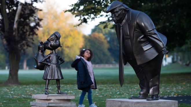 Two statues were standing in the park