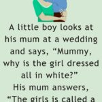 A little boy looks at his mum at a wedding