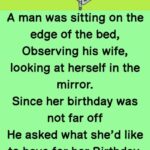 A man was sitting on the edge of the bed