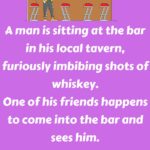 A man is sitting at the bar in his local tavern